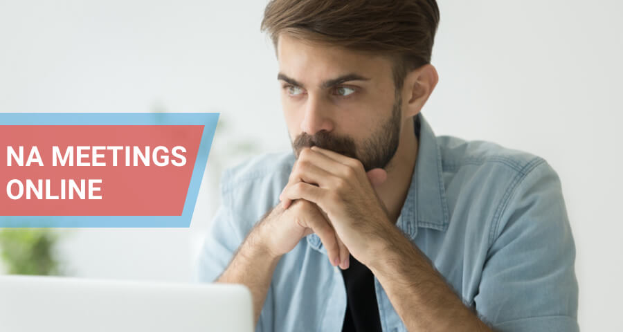 Man lost in thoughts in front of laptop.