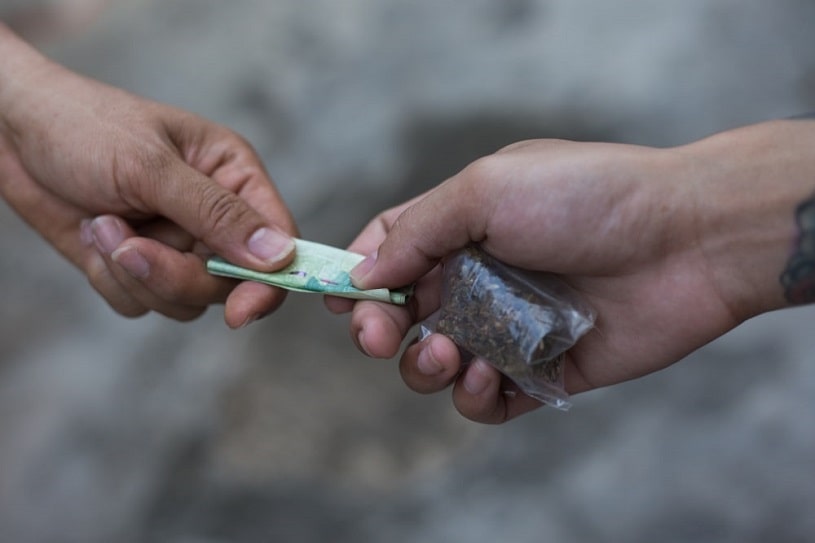 Drug addict buying street cannabis.