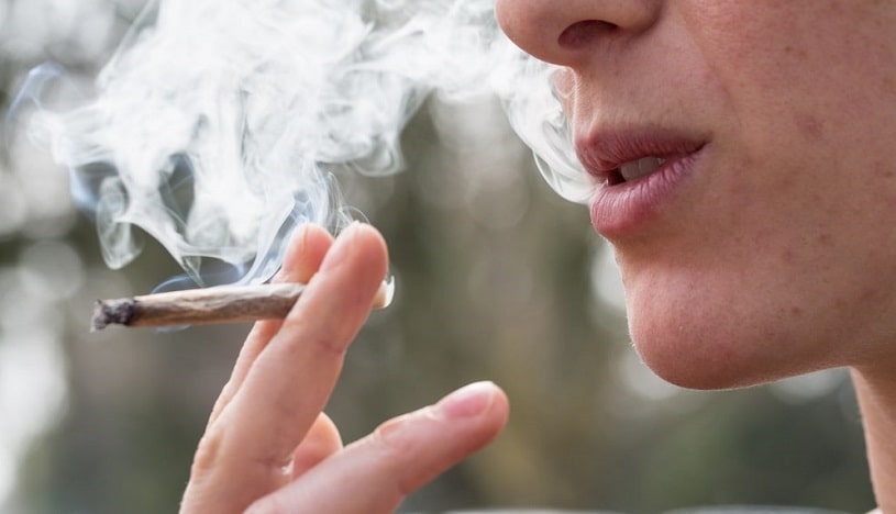 Young man smoking marijuana.