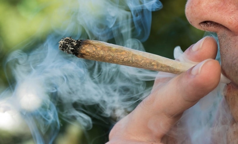 Man smoking marijuana on the street.
