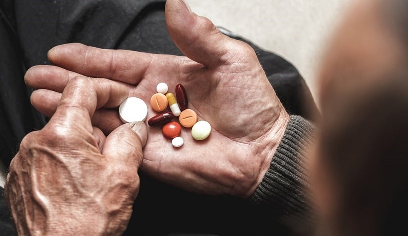 Man holding Valium and Xanax in hands.