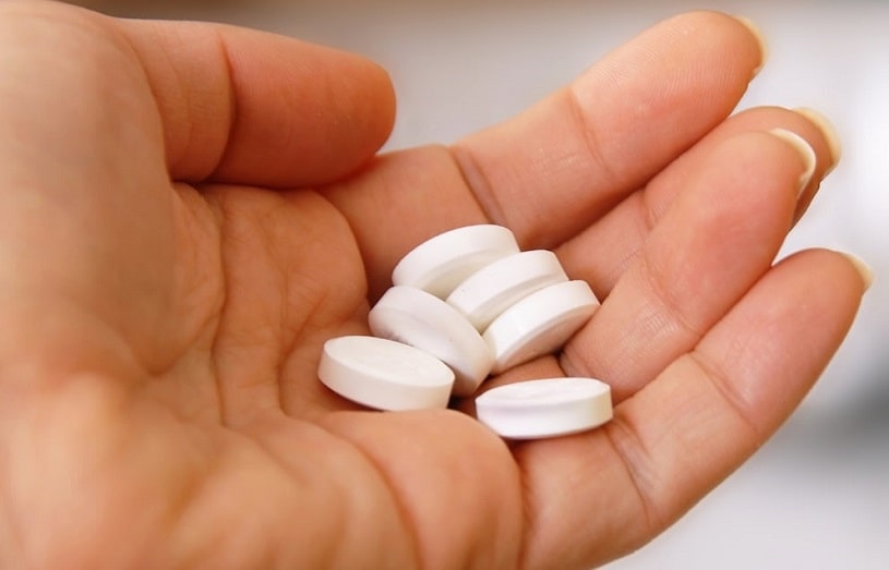 Percocet pills in hands.