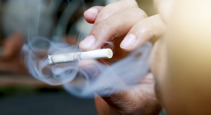 Man-smokes-a-cigarette-in-the-house.