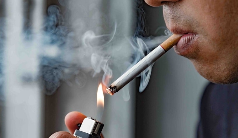 Man lighting a cigarette.