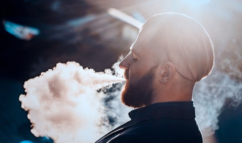 Vaping man exhaling a lot of vapor.