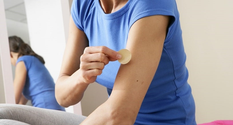 Nicotine addicted woman uses nicotine patch.