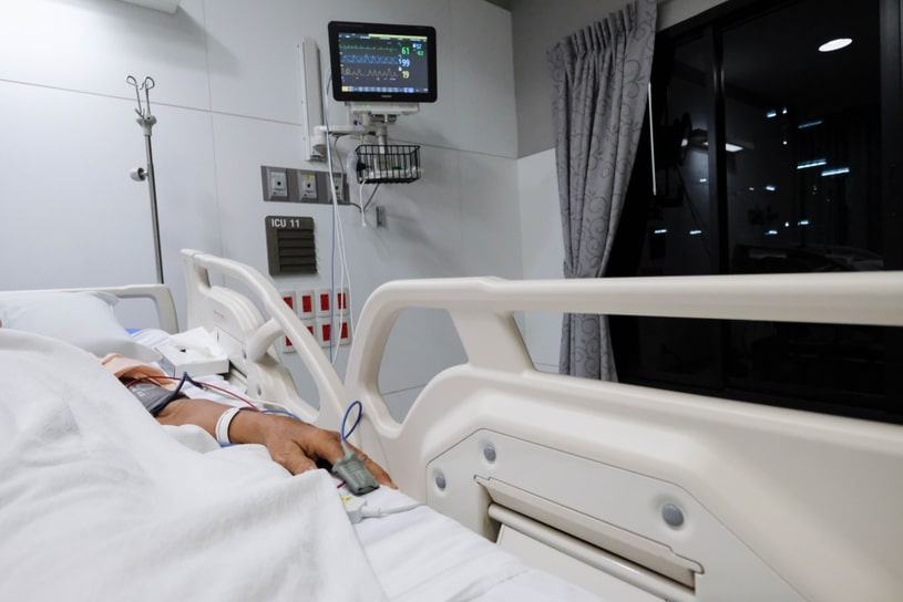 Someone is in the hospital with a sensor on his hand.