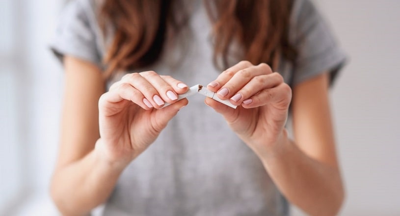 Woman breaking a cigarette.