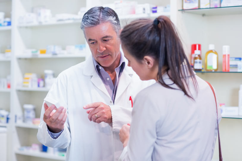 A man is showing different drugs in a drug store