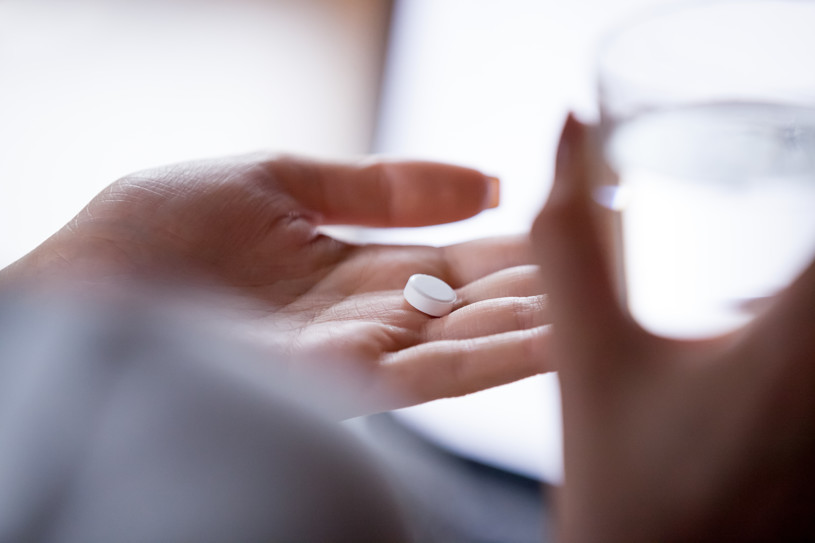 Flexeril pill in a hand.