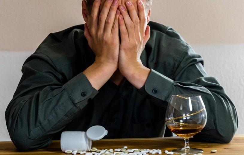 Man in pain taking codeine with alcohol.