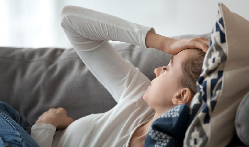 Woman holding her head suffering from codeine withdrawal.