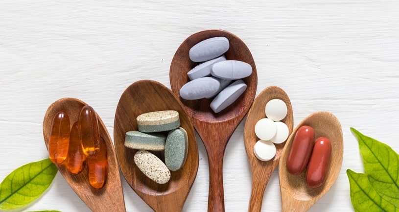 Different supplements including phenibut in wooden spoons.