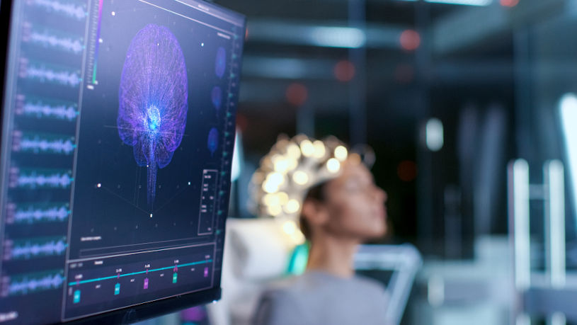 Woman wearing brainwave scanning headset.