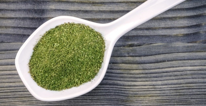 Kratom powder in a ceramic spoon.