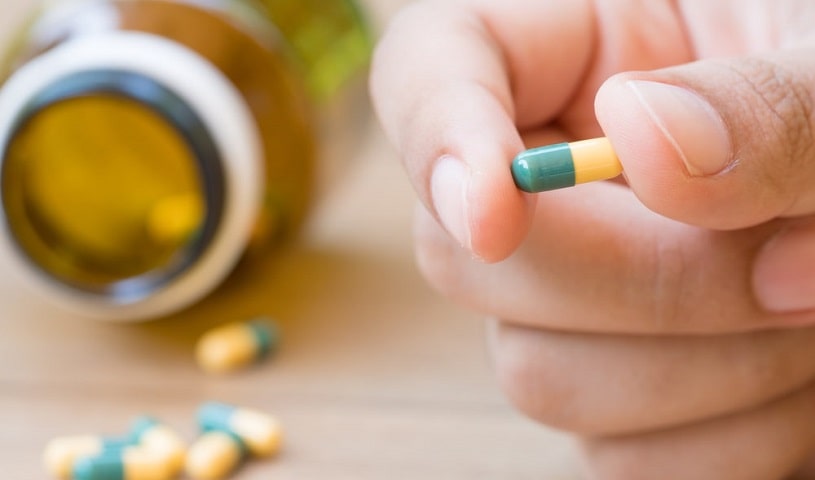 Tramadol pill in a man's hand.