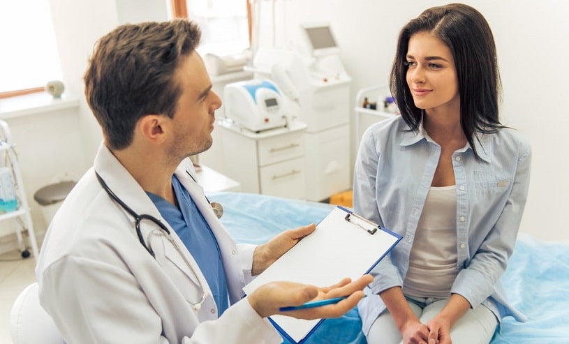 Doctor telling a patient about norco drug interactions in the hospital.