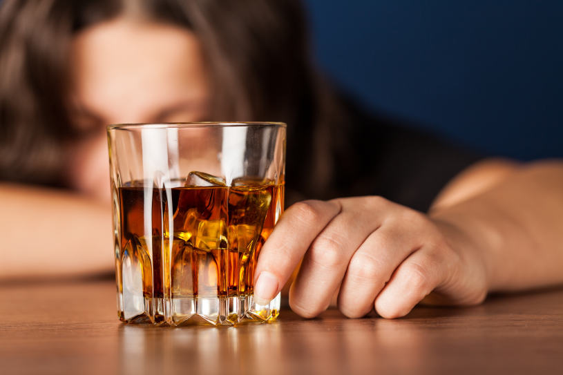 Woman with a glass of alcohol.