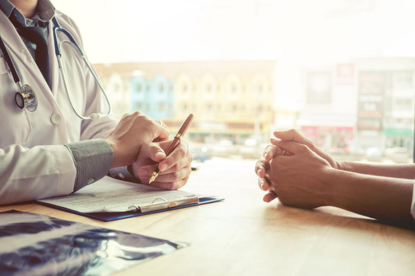 A doctor tells a patient about the possible treatment options to Midazolam abuse and addiction.