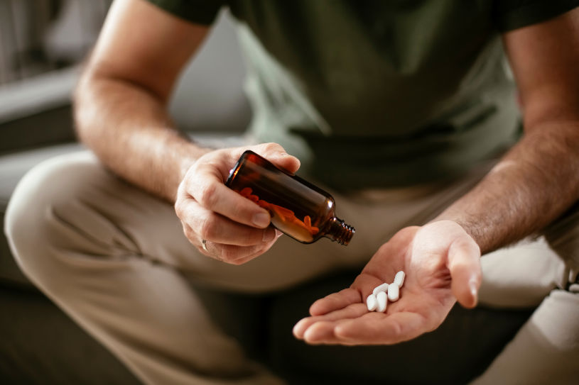 A man holds Phenazepam pills in his hand.