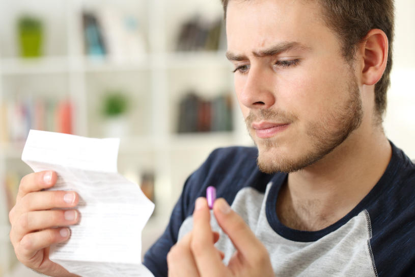 A man reads about Demerol side effects.
