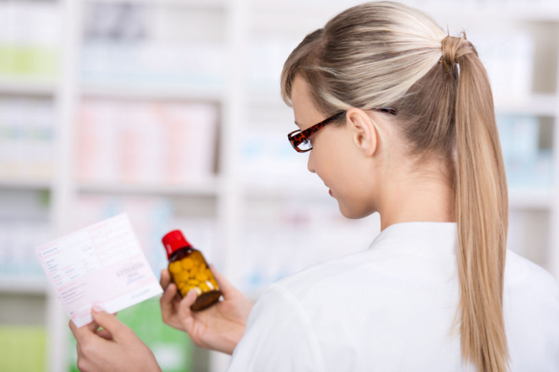A woman reads about Midazolam dosage.