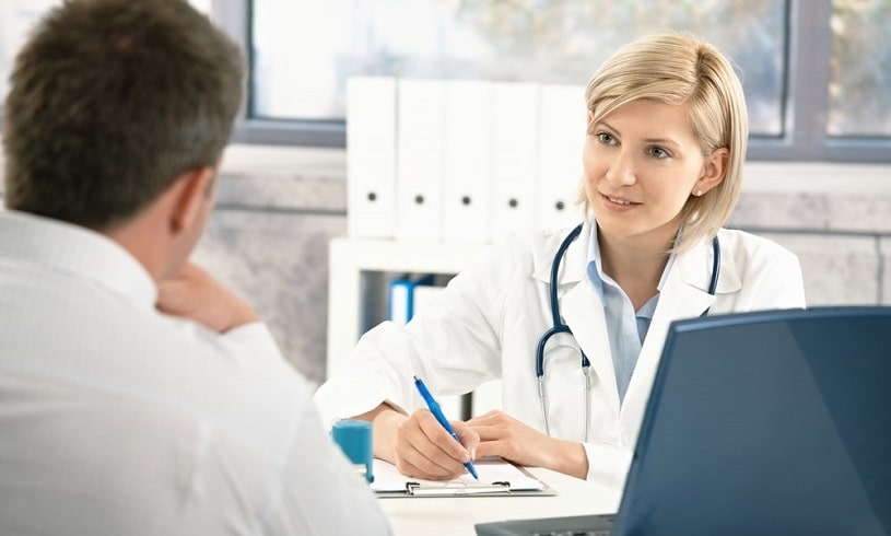 Doctor prescribing Probuphine implant to a patient, writing something.