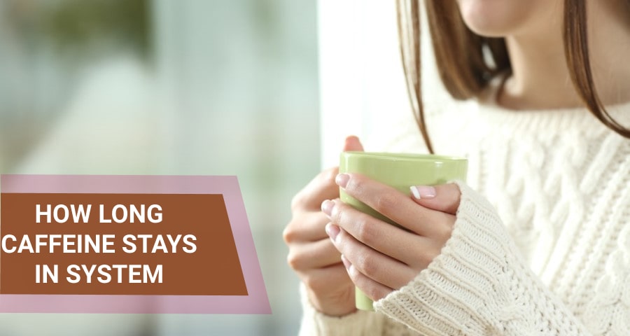 Woman in a sweater holding a cup of coffee.