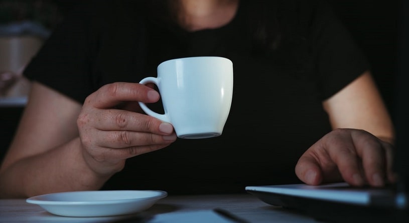 Man drinking coffee before sleep at night.