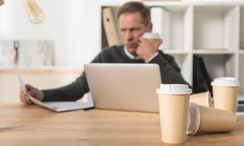 Stressed man drinking a lot of coffee.