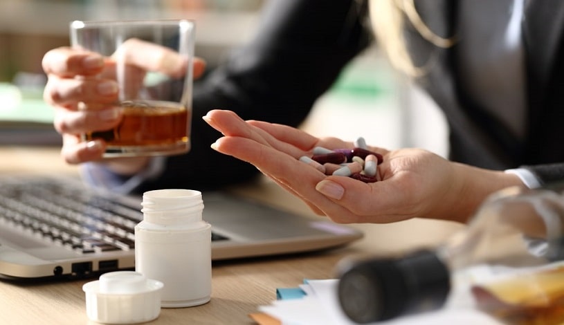 Woman at work taking Clonidine and alcohol.