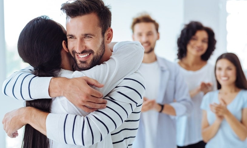 People hugging supporting each other.