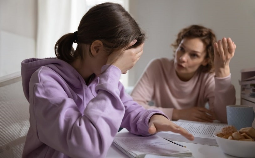 Mother trying to explain something to her daughter.