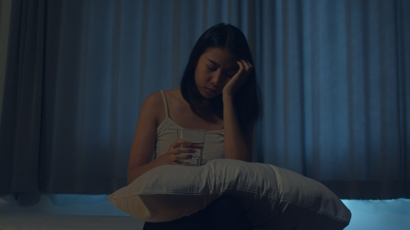 Depressed girl holds DXM meds.