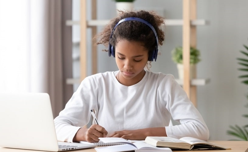 Concentrated girl doing her homework.