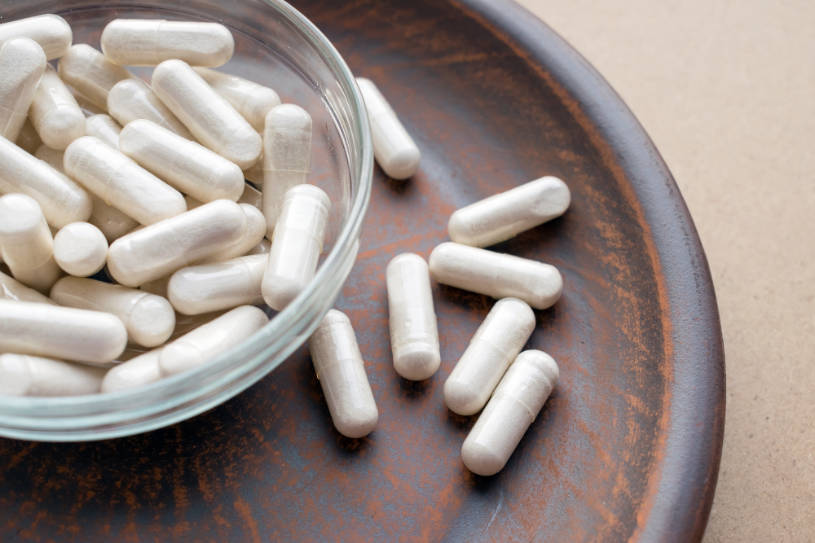 Kava and some pills on the table, hod does Kava interact with other drugs.