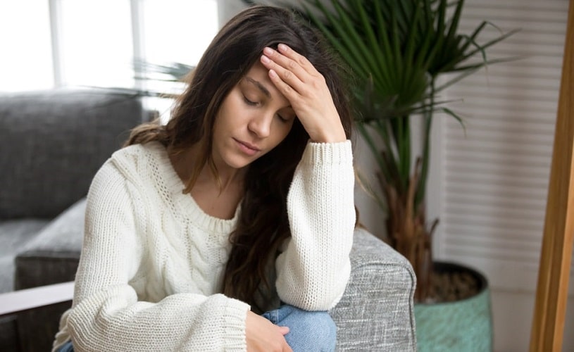 Woman experiencing Ritalin withdrawal at home.
