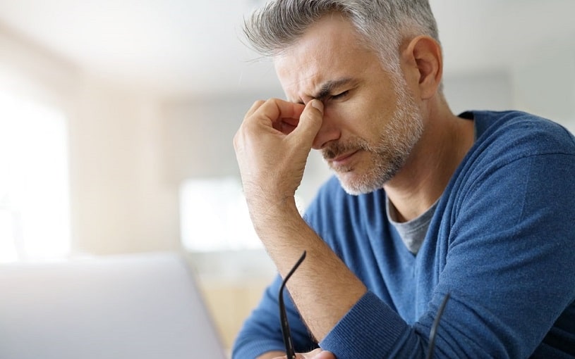 Man at home having a tension headache.