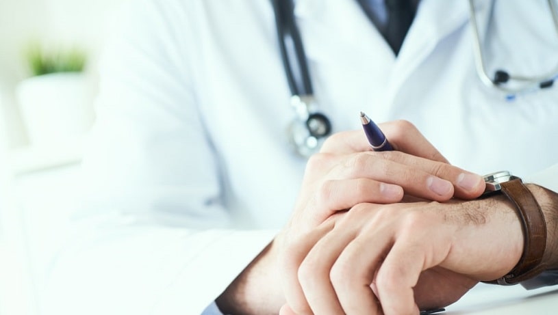 Man doctor looking at the watch.