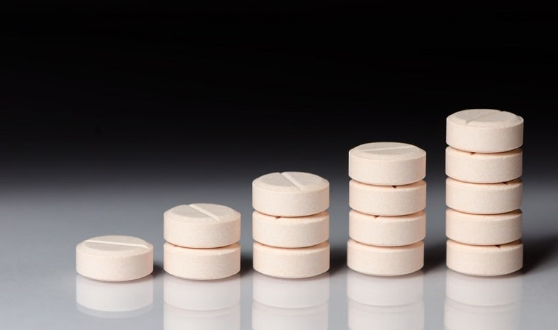 Round pills stacked in a row.