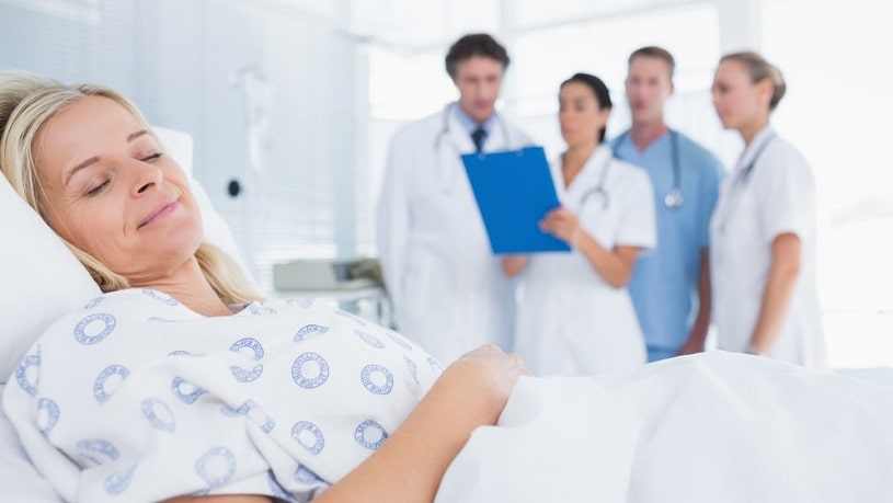 Woman recovering from oxycodone withdrawal in the hospital bed.