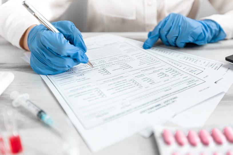 Doctor fills drug testing results form.