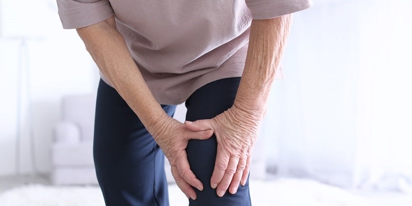 Man suffering arthritis pain at home.