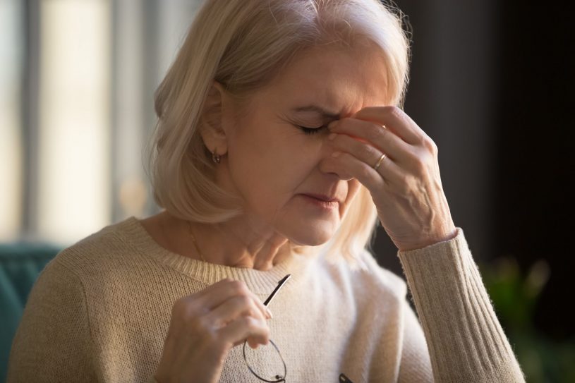Old lady feels a headache.
