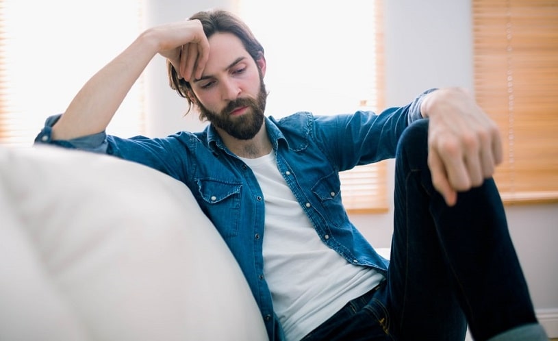 Man thinking on his sofa.