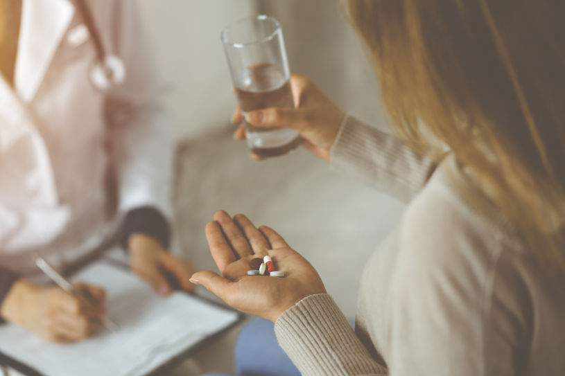 A woman on a consultation with a doctors asks about Vyvanse interactions.