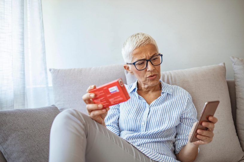 Woman is Checking Pill Ingredients