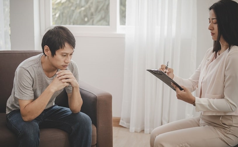 Addiction psychiatrist talking to the client.