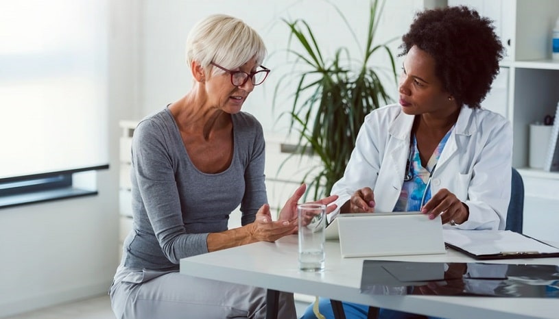 Doctor and patient talking about detox at home.