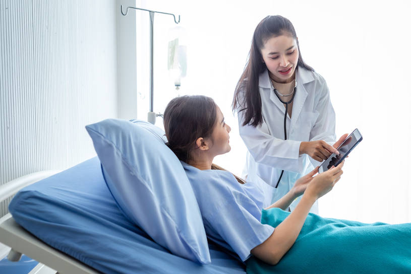 Asian female doctor helps patient during drug detox.